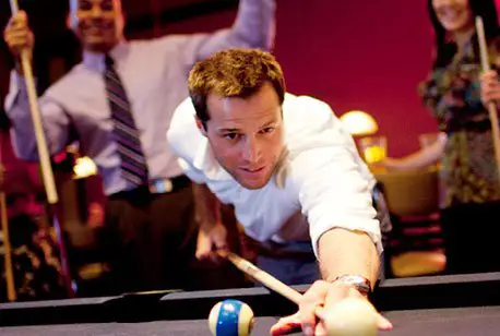 Playing billiards at Main Event. Family fun and entertainment