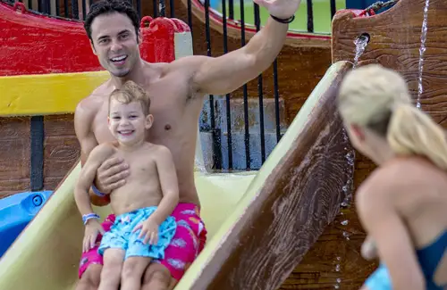 Father and child on slide at Pirate Ship at Schlitterbahn waterparks