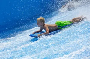 Boy at Schlitterbahn Waterpark in Galveston, TX body boarding