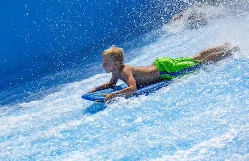 Boy at Schlitterbahn Waterpark in Galveston, TX body boarding