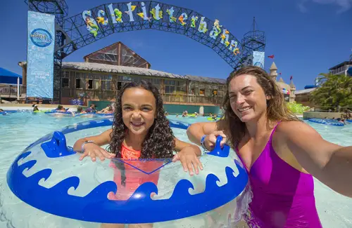 mom and child in lazy river on inner tubes at Schlitterbahn waterpark
