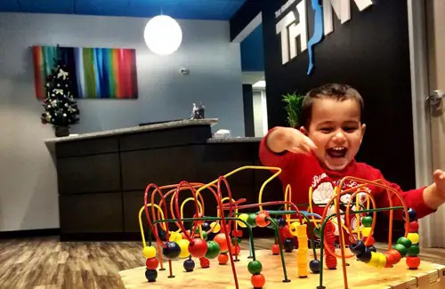 Child playing with toy in waiting area of THINK Institute; pediatric neurology; pediatric and adult healthcare