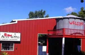 Entrance area to 7 Acre Wood; red barn with small silo says "Welcome"; family fun summer activities