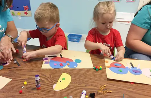 AB Sea Preschool; Two kids doing arts and crafts; preschool