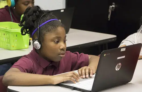 student on laptop at Arrow Academy