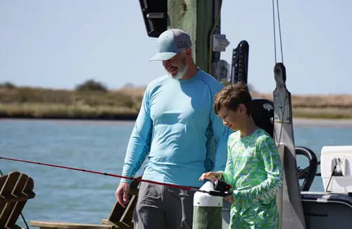 CCA-Texas-fishing-tournament-father-and-son-fishing-off-the-dock; Coastal Conservation Association Summer Fishing Tournament Adults Children Kids Texas College Scholarships Events Prizes
