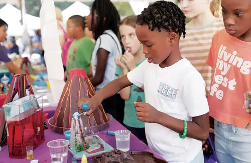 Houston Energy Day Festival; kid mixing ingredients for volcano