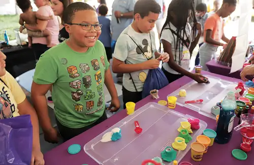 Houston Energy Day Festival; kids doing experiment at booth table