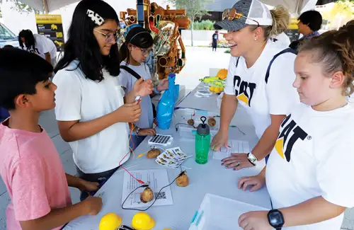 Houston Energy Day Festival; kids at booth table doing experiment with potato