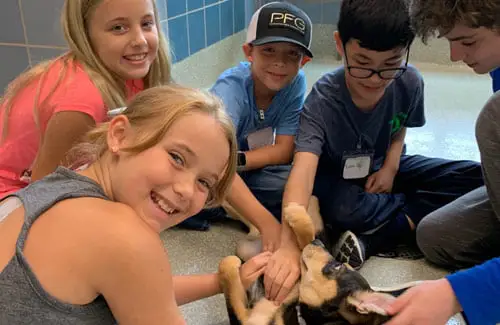 Houston SPCA Critter Camp-kids taking care of a dog; nature and science camps