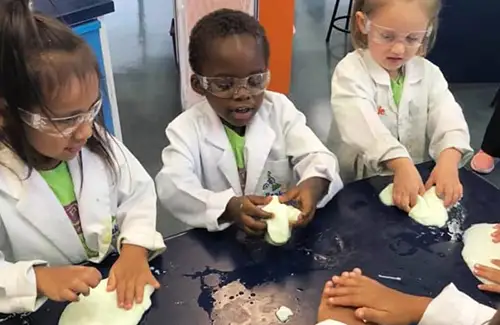 Students at Kids Clubhouse child care and preschool program doing some science experiments together; childcare preschool and schools