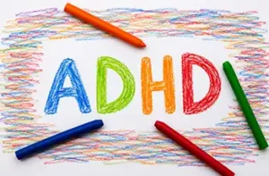Parenting Children With ADD and ADHD main blog image showing colored crayons laying on paper with the word ADHD colored in.