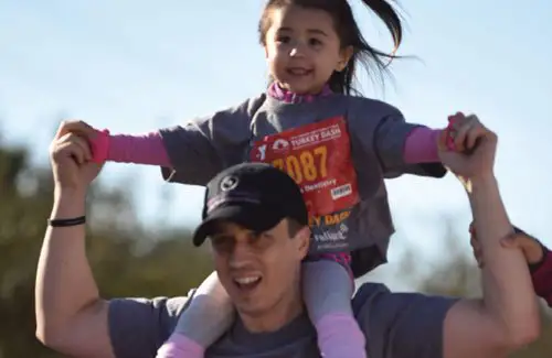 YMCA Katy Turkey Dash riding on dad's shoulders