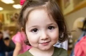 Adorable smiling little girl with ribbon in hair at Childtime Learning Centers; daycare summer camps