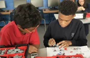 Corpus Christi Catholic School; two kids working on project in class; religious schools