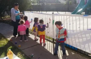 KIds painting outside of Distinct Abilities.