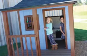 Children playing outside in a small house at Elements Montessori school; montessori preschool