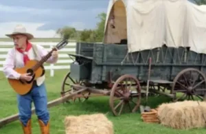 Cowboy singing by wagon at George Ranch Historical Park