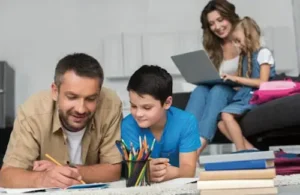 mother and father helping children with schoolwork in living room