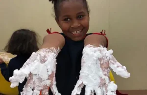 Playing with foam in the hands at Kids Resort Summer Program