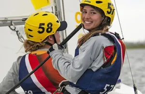 Two teens practice sailing in Galveston at Sea Star Base Galveston on small white sailboat; nature and science camps