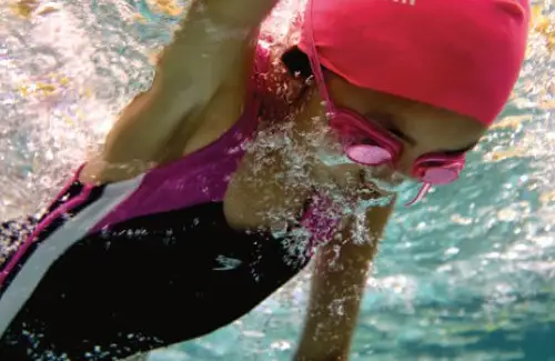 Child doing laps in pool at SwimLabs; learning to swim; swim school