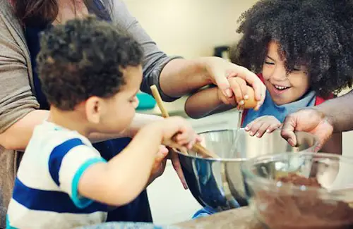 Cooking camp with two young chefs learning to mix ingredients in bowl at urban CHEF; baking cooking summer camps