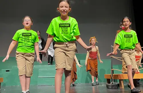 Kids on stage performing at A.D. Players Summer Theatre Camp.