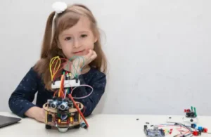 Girl showing off her robot she made at Learn to Bot; coding robotics summer camp.
