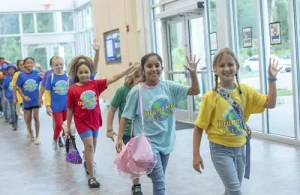 Summer camp group at Drama Kids waving hello. Theater camps and classes for kids.