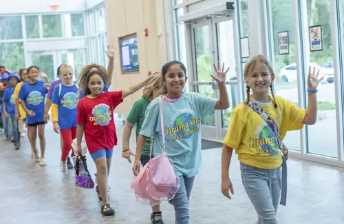 Summer camp group at Drama Kids waving hello. Theater camps and classes for kids.