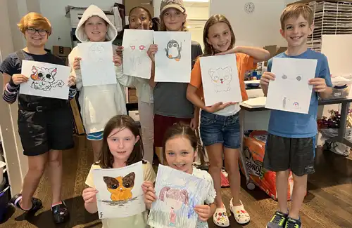 Summer art camp students showing their artwork at the Pearl Fincher Museum of Fine Arts.
