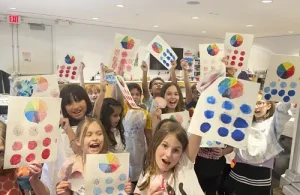 Pearl Fincher summer arts camp kids showing off their artwork.