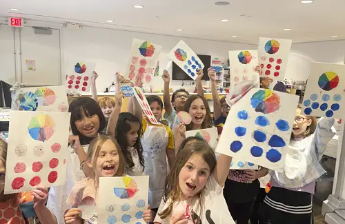 Pearl Fincher summer arts camp kids showing off their artwork.