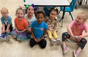 Children in group on classroom floor at Creative Corners Preschool.