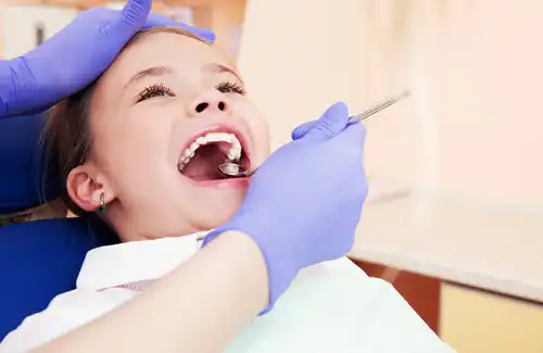 Gentle Dental Care dentist; pediatric and family dentists; girl getting teeth cleaned and checkup in office