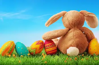 Easter Activities and Events 2025 blog cover pic; stuffed easter bunny sitting on grass with eggs next to it.