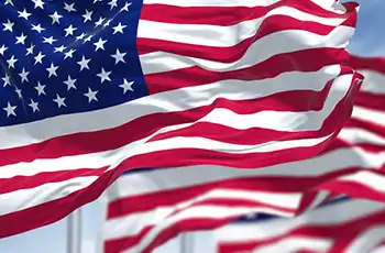 Texas Blue Star Museum 2025 blog article opening image of several American flags waving in the wind.