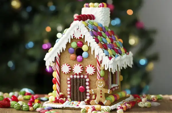 Discover The Magical Origins of Gingerbread Houses this Christmas; upclose shot of gingerbread house.