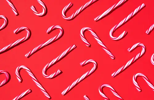 Sugar Land Art Center and Gallery candy canes on a red background.