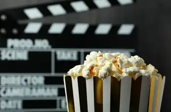 Main image for Free Family-Friendly Outdoor Movies 2026 blog article; clap board in back of a bucket of popcorn.
