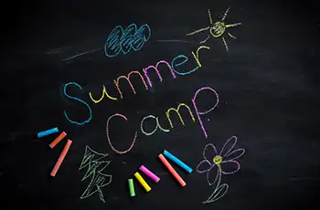 The Ultimate Guide to Summer Camps and Our Top Picks for 2026 main image showing Summer Camp text written on a chalk board; camps and educational programs.