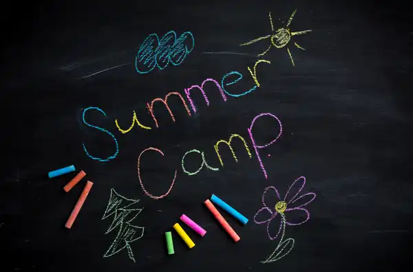 The Ultimate Guide to Summer Camps and Our Top 2026 Picks for 2026 main image showing Summer Camp text written on a chalk board.