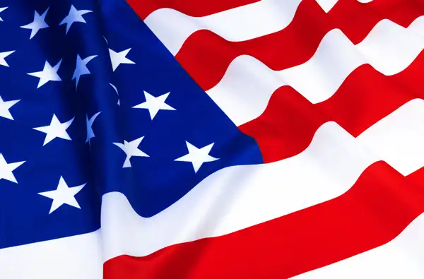 Texas Blue Star Museums 2026 blog article opening image of a large American flag waving in the wind.